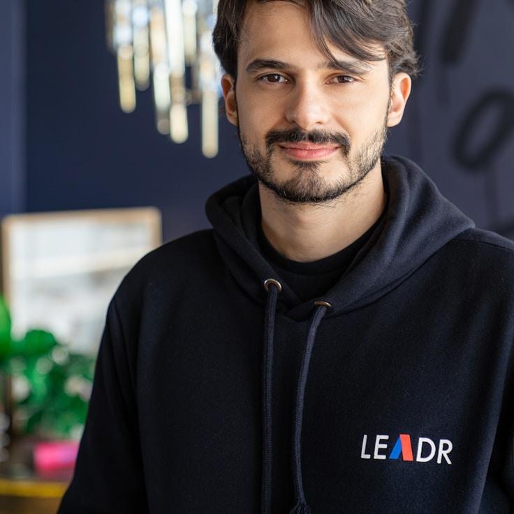 Nova Reed, Lead Design Curator at PaperFieldCrest, reviewing corporate floral arrangements